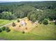 Aerial view of the large property surrounded by a lush forest, offering privacy and seclusion at 668 Spring Place Ne Rd, White, GA 30184