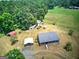 Sprawling property featuring a ranch-style home, outbuildings, and lush greenery at 668 Spring Place Ne Rd, White, GA 30184
