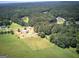 Expansive aerial view of a property surrounded by lush greenery and mature trees in a serene setting at 668 Spring Place Ne Rd, White, GA 30184