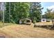 Spacious backyard featuring covered area and storage shed with lots of potential at 668 Spring Place Ne Rd, White, GA 30184