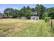 Expansive backyard featuring outbuildings and green space, offering potential for outdoor activities at 668 Spring Place Ne Rd, White, GA 30184