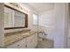 Bathroom with granite countertops, framed mirror, tile flooring, and bright lighting at 668 Spring Place Ne Rd, White, GA 30184