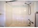 Shower/tub combination featuring grab bars and shower wand in all-white bathroom at 668 Spring Place Ne Rd, White, GA 30184