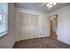Bedroom with a closet, large window, and carpeted flooring at 668 Spring Place Ne Rd, White, GA 30184