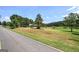 Picturesque home on a sprawling lawn featuring mature trees and a long driveway at 668 Spring Place Ne Rd, White, GA 30184