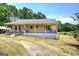 Inviting single-story home with a covered porch and ramp access, set on a spacious lot at 668 Spring Place Ne Rd, White, GA 30184