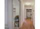 Hallway with wood floors and white trim, offering access to multiple rooms and storage at 668 Spring Place Ne Rd, White, GA 30184