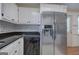 Well-appointed kitchen with stainless steel appliances, black countertops and white cabinets at 668 Spring Place Ne Rd, White, GA 30184