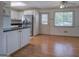 Cozy living room and dining room combination featuring stainless steel refrigerator and view to backyard at 668 Spring Place Ne Rd, White, GA 30184