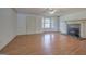 Bright living room with hardwood floors, large windows, a front door and fireplace with stone hearth at 668 Spring Place Ne Rd, White, GA 30184
