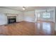 Open concept living room featuring wood floors, stone fireplace, and plenty of natural light at 668 Spring Place Ne Rd, White, GA 30184