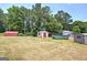 Variety of storage sheds in the property, offering ample space for tools and equipment, located in lush field at 668 Spring Place Ne Rd, White, GA 30184