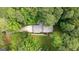 Aerial view showcases a well-maintained property with mature trees and a long driveway at 2179 Mountclaire Ct, Stone Mountain, GA 30087