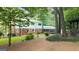 The backyard features a well-maintained lawn, a brick and siding home, and a cozy gazebo for enjoying the outdoors at 2179 Mountclaire Ct, Stone Mountain, GA 30087