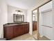 Bathroom featuring a dark wood vanity with granite counters, built in lighting, and a sliding door closet at 2179 Mountclaire Ct, Stone Mountain, GA 30087