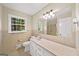 Well-lit bathroom featuring a large mirror, vanity, toilet, and shower at 2179 Mountclaire Ct, Stone Mountain, GA 30087