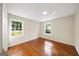 Neutral bedroom with hardwood floors and natural light from two windows at 2179 Mountclaire Ct, Stone Mountain, GA 30087