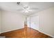 This bedroom features hardwood floors, a ceiling fan, and a double-door closet at 2179 Mountclaire Ct, Stone Mountain, GA 30087