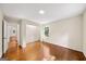 Spacious bedroom with hardwood floors, a closet, and a bright window at 2179 Mountclaire Ct, Stone Mountain, GA 30087