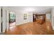 Open dining area with hardwood floors connecting to a kitchen with a wood-covered island at 2179 Mountclaire Ct, Stone Mountain, GA 30087