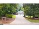 Long driveway leads to a home with a two-car garage, and surrounded by lush landscaping at 2179 Mountclaire Ct, Stone Mountain, GA 30087