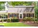 Traditional brick home featuring symmetrical design, black shutters, and well-maintained landscaping at 2179 Mountclaire Ct, Stone Mountain, GA 30087