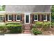 Well-kept brick home with symmetrical windows and door, complemented by trimmed bushes at 2179 Mountclaire Ct, Stone Mountain, GA 30087