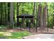 Beautiful gazebo in a wooded area surrounded by mature trees and a black metal fence at 2179 Mountclaire Ct, Stone Mountain, GA 30087
