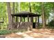 Rustic wooden gazebo nestled among trees, offering a private and shaded retreat at 2179 Mountclaire Ct, Stone Mountain, GA 30087