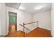 Upstairs hallway with hardwood floors and white trim, leading to the bedrooms and other living spaces at 2179 Mountclaire Ct, Stone Mountain, GA 30087
