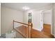 Hardwood hallway showing the white front door, stairs to the upper level, and doorways to other rooms at 2179 Mountclaire Ct, Stone Mountain, GA 30087