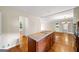Kitchen with a wooden island, cooktop, and hardwood floors connects to other rooms at 2179 Mountclaire Ct, Stone Mountain, GA 30087