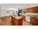 Kitchen featuring an island cooktop, wood cabinets, and granite countertops at 2179 Mountclaire Ct, Stone Mountain, GA 30087