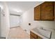 Practical laundry room with built in cabinets, sink, and washer dryer hookups at 2179 Mountclaire Ct, Stone Mountain, GA 30087