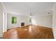 Bright living room with hardwood floors, fireplace, ceiling fan, and large windows overlooking the backyard at 2179 Mountclaire Ct, Stone Mountain, GA 30087