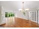 Bright living room boasts hardwood floors, a brick fireplace, and large windows showcasing a view at 2179 Mountclaire Ct, Stone Mountain, GA 30087