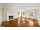 Inviting living room with hardwood floors, fireplace, and large windows providing natural light at 2179 Mountclaire Ct, Stone Mountain, GA 30087