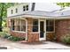 Sunroom with large windows and a brick exterior at 2179 Mountclaire Ct, Stone Mountain, GA 30087