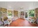 Bright sunroom with brick and large windows, creating a cozy space to relax and enjoy the outdoors at 2179 Mountclaire Ct, Stone Mountain, GA 30087
