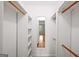 Walk-in closet features built-in shelving and hanging rods, providing ample storage space with a full length mirror at 2179 Mountclaire Ct, Stone Mountain, GA 30087