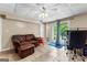 Finished basement with tile flooring, sliding glass door, and recreational area with leather sofa at 345 Wynbrook Dr, Mcdonough, GA 30253