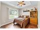 Sun-filled bedroom with wood floors, ceiling fan, and views of the neighborhood at 345 Wynbrook Dr, Mcdonough, GA 30253