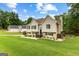 Expansive front lawn leads to a well-maintained home with mature trees at 345 Wynbrook Dr, Mcdonough, GA 30253