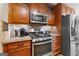 Kitchen featuring stainless steel appliances, granite countertops, and warm wood cabinetry at 345 Wynbrook Dr, Mcdonough, GA 30253