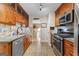 Galley kitchen with granite counters, stainless steel appliances, and wood cabinets at 345 Wynbrook Dr, Mcdonough, GA 30253