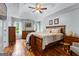 Spacious main bedroom with tray ceiling, hardwood floors, and natural light at 345 Wynbrook Dr, Mcdonough, GA 30253