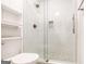 The bathroom boasts a frameless glass shower with white tiling and pebble stone floor at 503 Countryside Se Pl, Smyrna, GA 30080