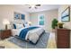 Staged bedroom with soft decor and plenty of natural light from the large window at 503 Countryside Se Pl, Smyrna, GA 30080