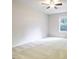 A cozy bedroom with a ceiling fan and a large window bringing in natural light at 503 Countryside Se Pl, Smyrna, GA 30080