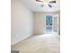 Bright bedroom with plush carpet, ceiling fan, and door to outdoor patio at 503 Countryside Se Pl, Smyrna, GA 30080